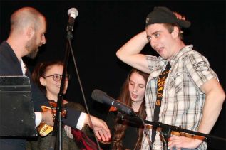 Zach Teal receives his trophy for winning Frontenac’s Got Talent from emcee Rob Moore last Friday night in Sharbot Lake. Photo/Craig Bakay